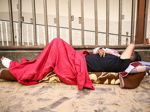 A wounded Palestinian man lies on a stretcher at the floor of the Baptist Hospital in Gaza City, on March 31, 2024.