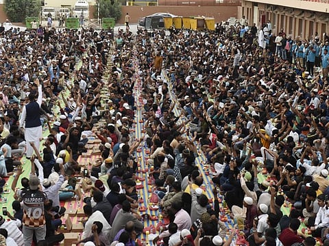 Thousands of people ending their day's fast with meals sponsored by Malawian brothers Imran and Mohammed Karim at a workers' accommodation complex in Jebel Ali, Dubai