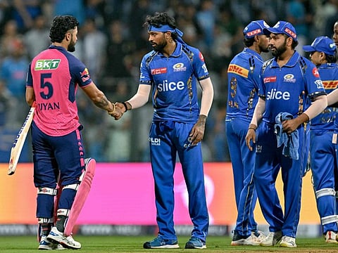Mumbai Indians' captain Hardik Pandya greets Rajasthan Royals' Riyan Parag (left) as Rohit Sharma watches at the end of the IPL match at home on Monday.