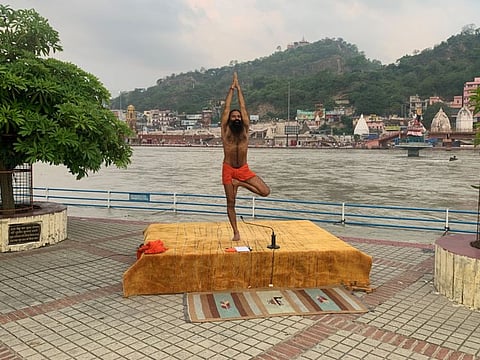 Baba Ramdev performs yoga on the banks of the river Ganges ahead of International Yoga day, in the northern town of Haridwar, India, June 19, 2020.