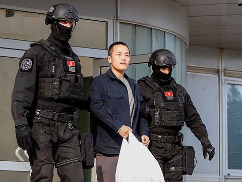 Police officers escort Terraform Labs co-founder Do Kwon after he served a sentence for document forgery, in Podgorica, Montenegro.