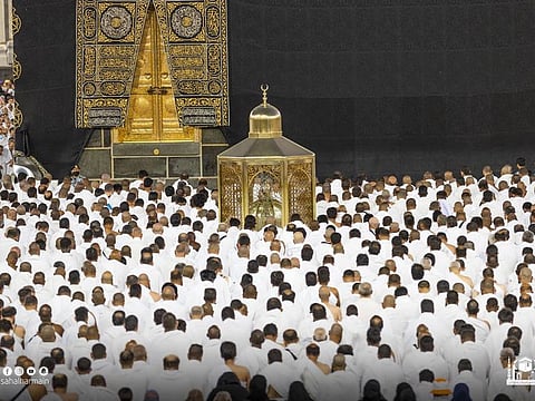 Muslims clad in white Umrah robes gather around the Holy Kaaba at the Grand Mosque in Mecca.