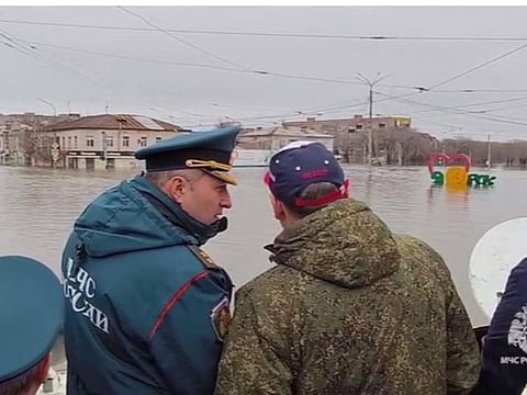 This photo taken from a video released by the Russian Emergency Situations Ministry on April 7, 2024 shows rescuers inspecting a flooded area in the town of Orsk, Orenburg region, southeast of the southern tip of the Ural Mountains.