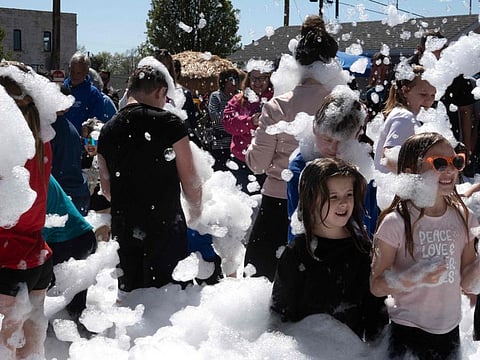 Residents enjoy a foam party that was part of the town's celebration of the April 8 solar eclipse on April 06, 2024 in Perryville, Missouri. Communities across the country in the path of totality of the April 8 eclipse are holding festivals and preparing to host a massive influx of visitors to view the rare celestial phenomenon.