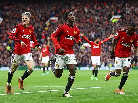 Manchester United's Kobbie Mainoo celebrates scoring their second goal with Aaron Wan-Bissaka and Alejandro Garnacho during their Premier League match at Old Trafford.