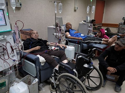 Palestinian men receive treatment in the kidney dialysis area at the Al Aqsa Martyrs Hospital in Deir Al Balah, central Gaza Strip, on April 9, 2024.