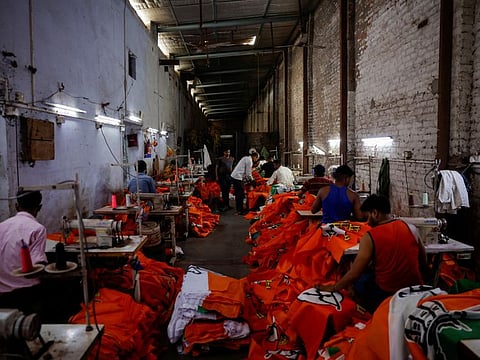 Workers stitching flags at a flag manufacturing factory in Mathura, India, March 29, 2024.