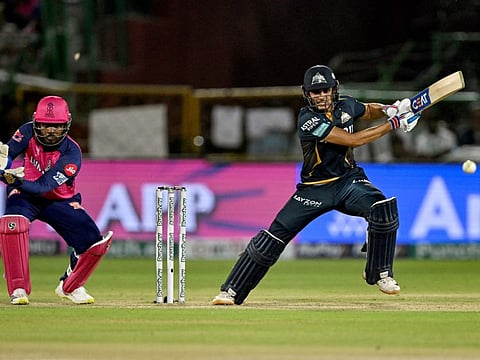Gujarat Titans' captain Shubman Gill in action as Rajasthan Royals' wicketkeeper and captain Sanju Samson watches during the Indian Premier League match at the Sawai Mansingh Stadium in Jaipur on Wednesday.