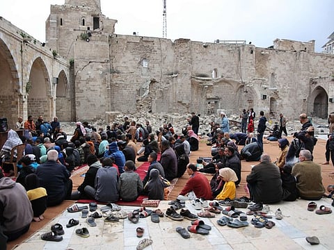 Palestinian worshippers gather on April 10, 2024 in the courtyard of Gaza City's historic Omari Mosque, which has been heavily damaged in Israeli bombardment during the ongoing battles between Israel and Hamas, on the first day of Eid Al Fitr.