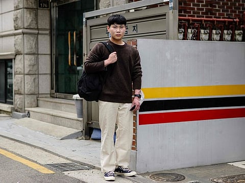 Kim Yeong-kwang, 21, who recently completed military service and is now a university student majoring in food engineering, poses on a street in Seoul on April 10, 2024, after voting at a nearby polling station during the parliamentary election.