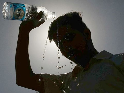 Drinking water and pouring it over the head and body helps the recovery from heat exhaustion. Image used for illustrative purpose only.