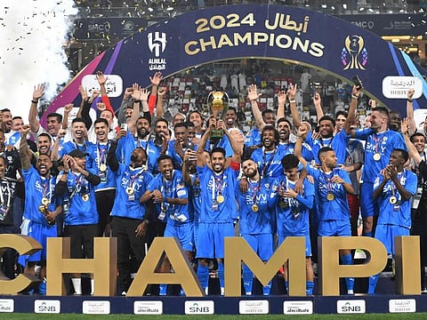 Al Hilal players celebrate with the trophy after winning the Saudi Super Cup final against Al Ittihad at Mohammed Bin Zayed Stadium in Abu Dhabi on Thursday.