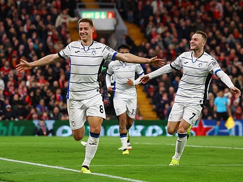 Atalanta's Mario Pasalic celebrates with Teun Koopmeiners after scoring their third goal against Liverpool at Anfield on Thursday.
