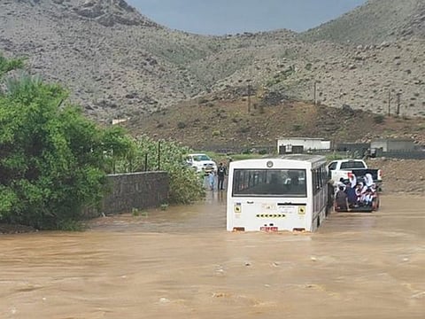 Trapped vehicles in Oman's Wadi Al Shibbak in Izki on Sunday.