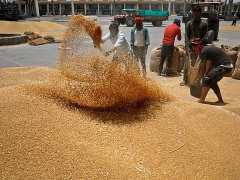 Workers sift wheat before filling in sacks at the market yard on the outskirts of Ahmedabad, India. India badly needs good monsoon rains as below-normal rainfall in 2023 depleted reservoir levels and hit food production.
