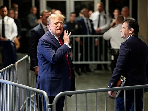 Trump gestures outside the courtroom on the day of a court hearing on charges of falsifying business records to cover up a hush money payment to a porn star before the 2016 election, in New York State Supreme Court in the Manhattan borough of New York City, on February 15, 2024.