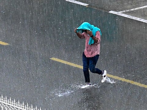 A Sharjah resident caught in the rain in Al Majaz on April 16, 2024. Rain is fine if don’t have to go to school or office.