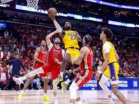 Los Angeles Lakers forward LeBron James shoots against New Orleans Pelicans forward Larry Nance Jr. during a play-in game of the 2024 NBA playoffs at Smoothie King Centre.