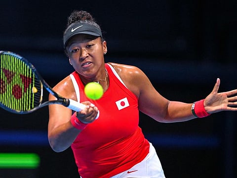 Japans Naomi Osaka hits a return to Kazakhstans Yulia Putintseva during their women's singles match of the Billie Jean Cup tennis qualifying tie in Tokyo.