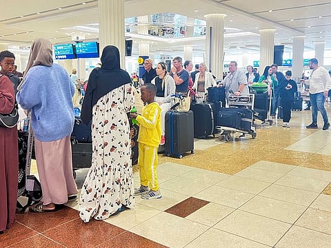 People queue at the check-in counter after a rainstorm hits Dubai, causing delays at the Dubai International Airport, in Dubai, United Arab Emirates, April 17, 2024