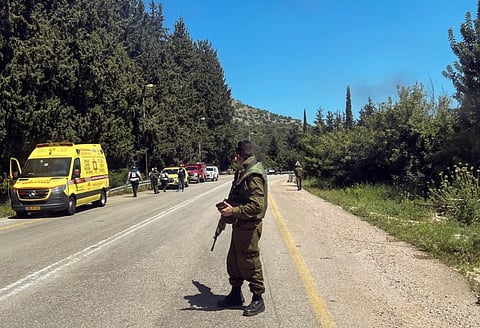 An Israeli soldier looks on at the scene, after it was reported that people were injured, amid ongoing cross-border hostilities between Hezbollah and Israeli forces, near Arab Al Aramashe in northern Israel April 17, 2024.