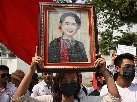 Protesters hold an image of detained civilian leader Aung San Suu Kyi during a demonstration outside the UN office in Bangkok on February 1, 2024, to mark the third anniversary of the coup in Myanmar.