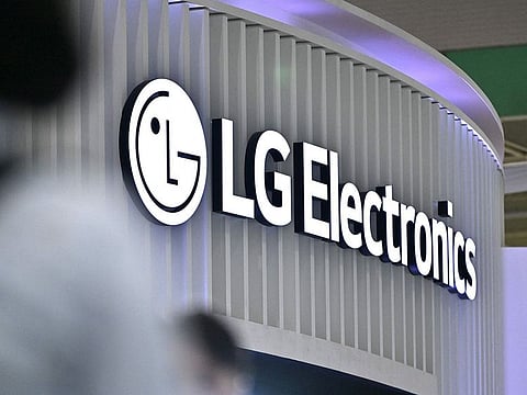 Visitors walk past the logo of LG Electronics during the 2024 World IT Show in Seoul.
