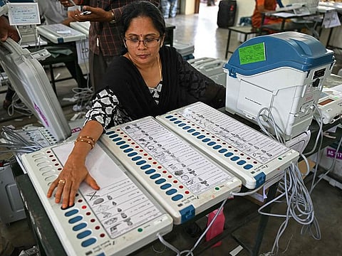 A poll official works on Electronic Voting Machines (EVMs) at a distribution center in Coimbatore on April 11, 2024, ahead of the country's upcoming general elections. Voting in India's six-week election begins April 19, 2024, with 968 million people eligible to cast their ballots in the world's biggest democratic vote.