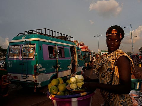 A street vendor sells oranges at a mini bus station in Bamako, Mali.
