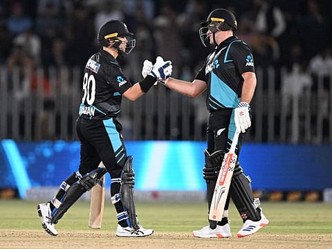 New Zealand's Mark Chapman (left) celebrates a boundary with Dean Foxcroft during the third Twenty20 international cricket match against Pakistan at the Rawalpindi Cricket Stadium on Sunday.