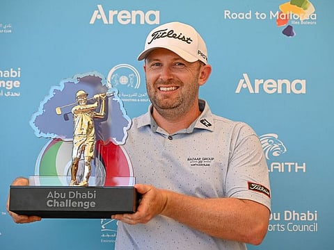 Garrick Porteous celebrates with the trophy in Al Ain