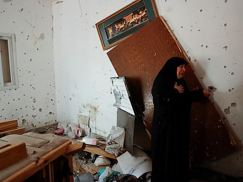 A Palestinian woman reacts to the damage following an Israeli raid at Nur Shams camp, in Tulkarem, in the Israeli-occupied West Bank, April 21, 2024.