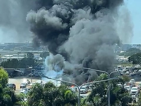 A grass fire at Manila's international airport ignited 19 vehicles in a car park.
