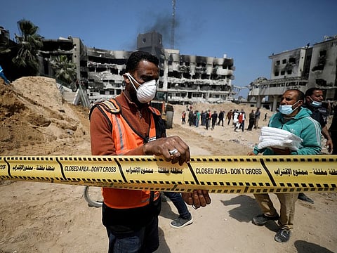 File photo: A man tapes off the area as rescuers and medics search for dead bodies inside the damaged Al Shifa Hospital after Israeli forces withdrew from the hospital and the area around it following a two-week operation, in Gaza City April 8, 2024.