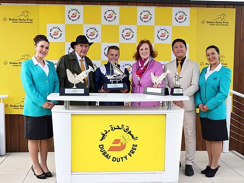 Tom Marquand receives his trophy from Colm McLoughlin, Sinead El Sibai and Bernard Aquino after the Group 3 Dubai Duty Free Finest Surprise Stakes.