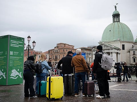 Tourists stand in front of Santa Lucia train station in Venice.