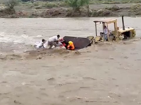 Amid the dangerous conditions, with torrential waters threatening to sweep them away, Ayed bin Daghash Al Aklabi, aided by two civil defence personnel aboard his bulldozer, navigated through the waters to reach the victims.