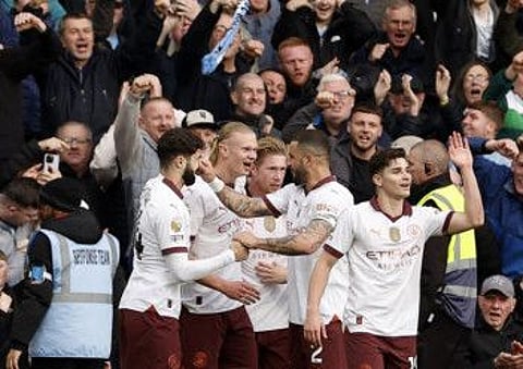 Manchester City's Erling Braut Haaland celebrates scoring their second goal with teammates during a Premier League match against Nottingham Forest at The City Ground on Sunday.