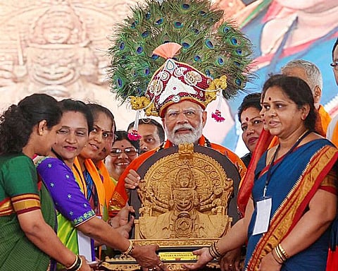 Prime Minister Narendra Modi being felicitated during a public meeting in support of Bharatiya Janata Party (BJP) candidate from Uttara Kannada seat Vishweshwar Hegde Kageri for the third phase of the Lok Sabha elections, in Uttara Kannada on Sunday.