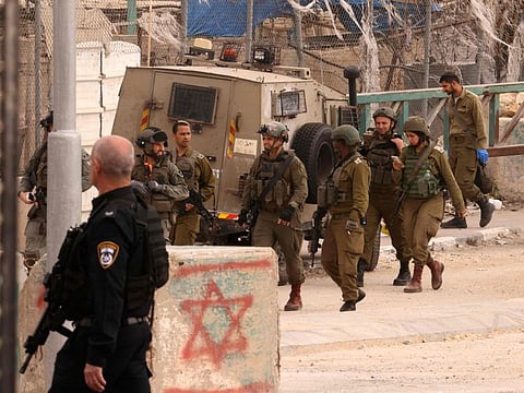 Israeli security forces cordon off the site of a reported attack at the Beit Einun junction, east of the West Bank city of Hebron on April 21, 2024.  The United States provides military aid to allies around the world, including Israel.