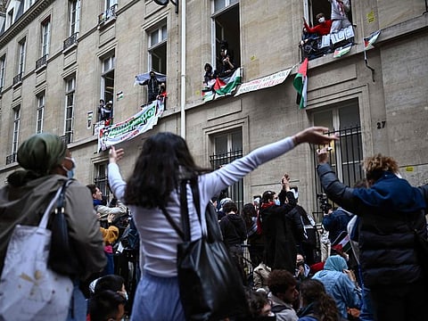 Protesters dance as they stage a sit-in near the entrance of a Institute of Political Studies (Sciences Po Paris) building occupied by students, in Paris.