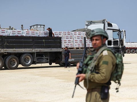 An Israeli soldier stands guard near humanitarian aid near the Erez Crossing point in northern Gaza, May 1, 2024.