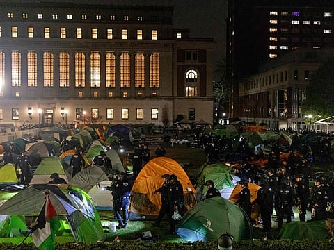 NYPD officers in riot gear enter Columbia University's encampment as they evict a building that had been barricaded by pro-Palestinian student protesters in New York City on April 30, 2024.