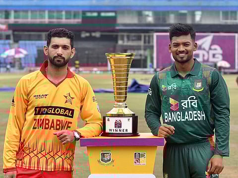 Bangladeshs captain Najmul Hasan Santo (right) and Zimbabwe's captain Sikandar Raza pose for a picture with the series trophy at the Zahur Ahmed Chowdhury Stadium in Chittagong on Thursday.