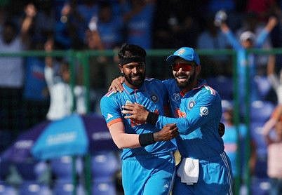 India's Virat Kohli celebrates after the wicket of Afghanistan's Rahmanullah Gurbaz off the bowling of Hardik Pandya at Arun Jaitley Stadium on October 11, 2023.