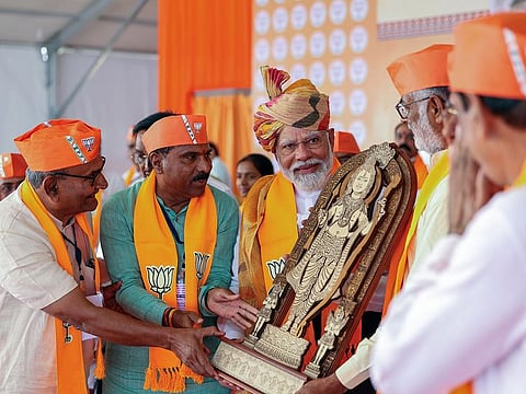 India's Prime Minister Narendra Modi being felicitated during a public meeting ahead of the Lok Sabha polls, at Deesa in Banaskantha on Wednesday.