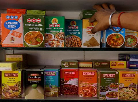 FILE PHOTO: A man adjusts the spice boxes of MDH and Everest on the shelf of a shop at a market in New Delhi, India, April 29, 2024. REUTERS/Adnan Abidi/File Photo