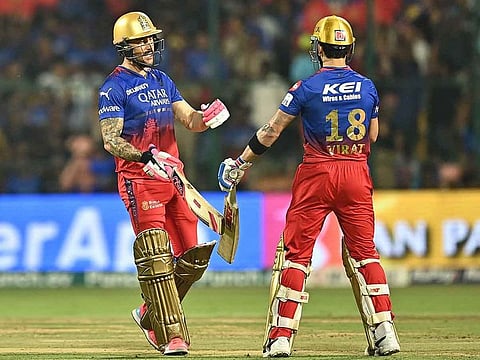 Royal Challengers Bengaluru's captain Faf du Plessis (L) greets teammate Virat Kohli during the Indian Premier League (IPL) Twenty20 cricket match between Royal Challengers Bengaluru and Gujarat Titans at the M Chinnaswamy Stadium in Bengaluru on May 4, 2024.