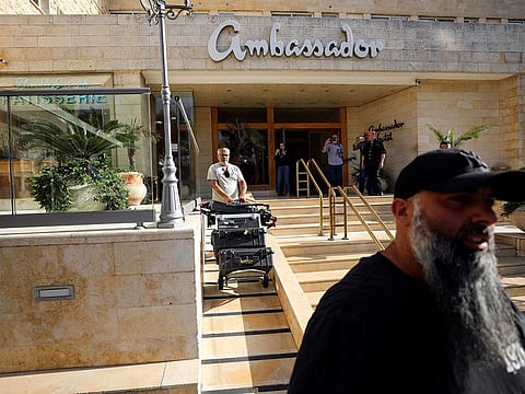 A man manoeuvres media equipment following an Israeli police raid on an Al Jazeera de facto office at the Ambassador Hotel in Jerusalem on Sunday.