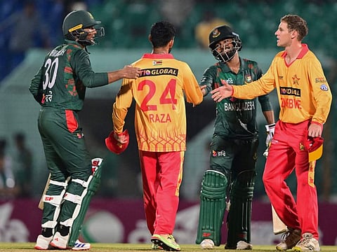 Bangladeshs cricketers shake hand with Zimbabwes cricketers after winning the second Twenty20 international cricket match at the Zahur Ahmed Chowdhury Stadium in Chittagong on Sunday.